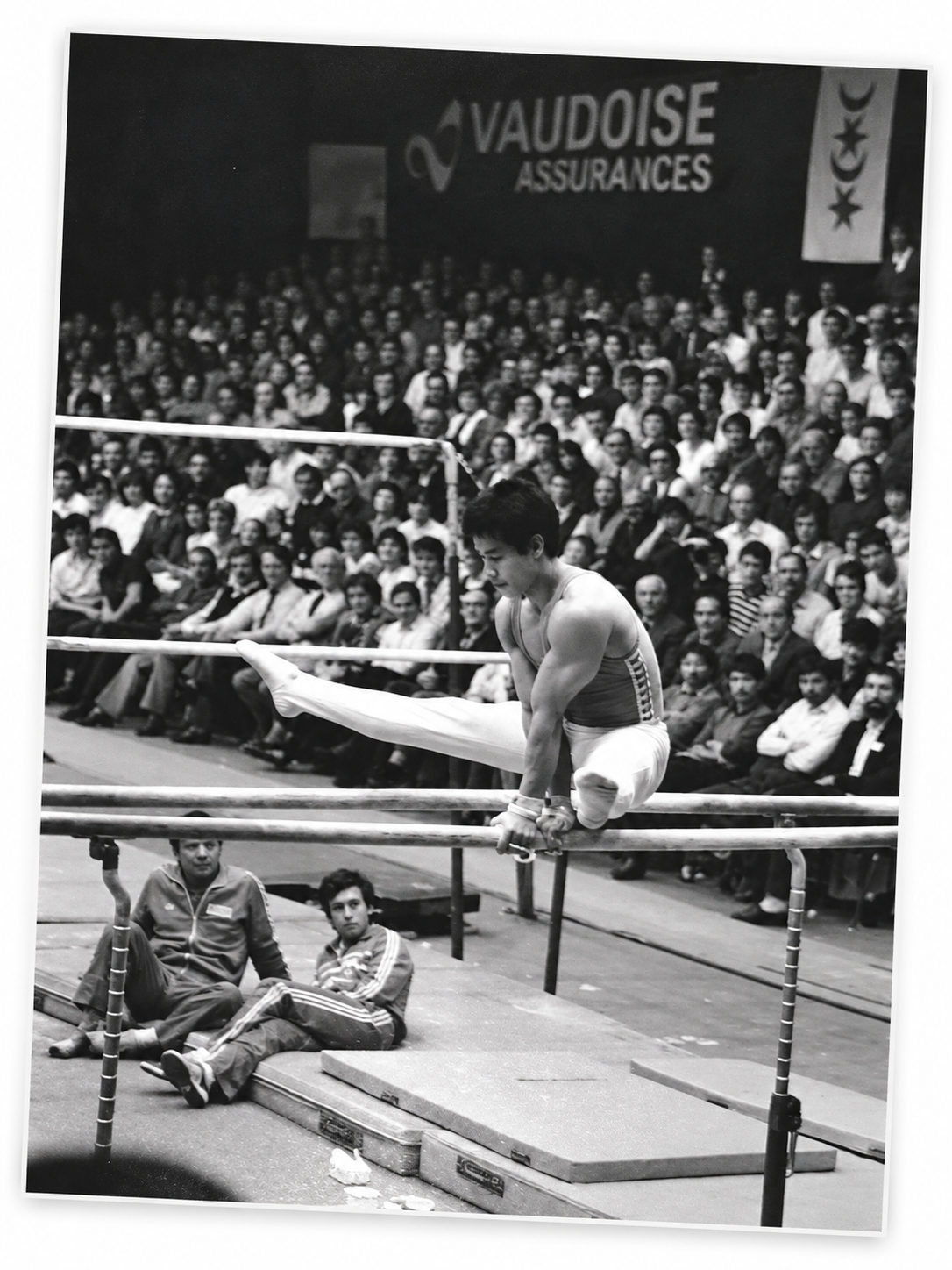 Chinese gymnast Li Ning performing on the parallel bars in front of a large audience during his visit to Montreux in 1985.